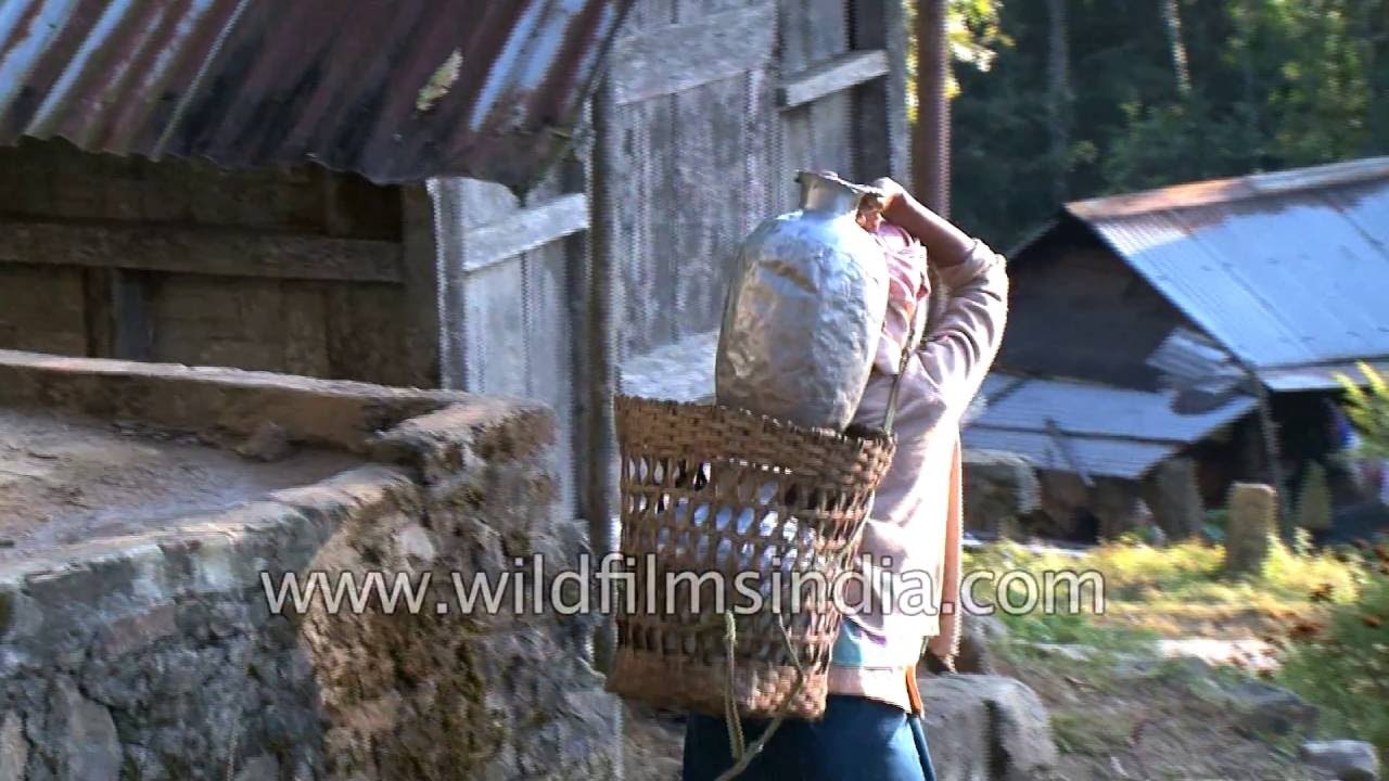 Lotha woman carries water to her house in Yikhum village, Nagaland
