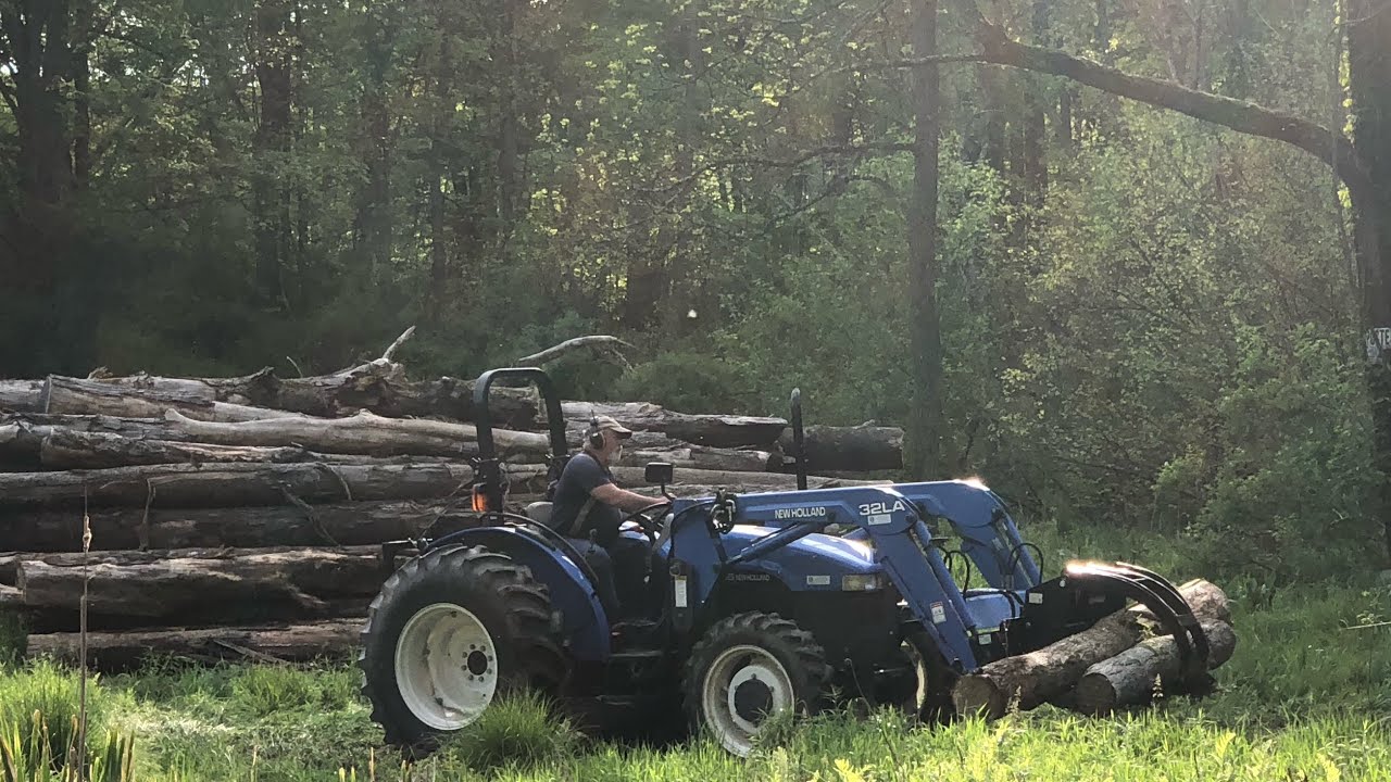 #207 New Holland tractor moving and hauling logs!