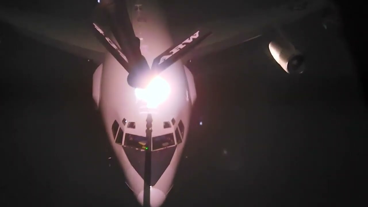 USAF KC-135 Stratotanker night refueling an E-3 Sentry over Middle East
