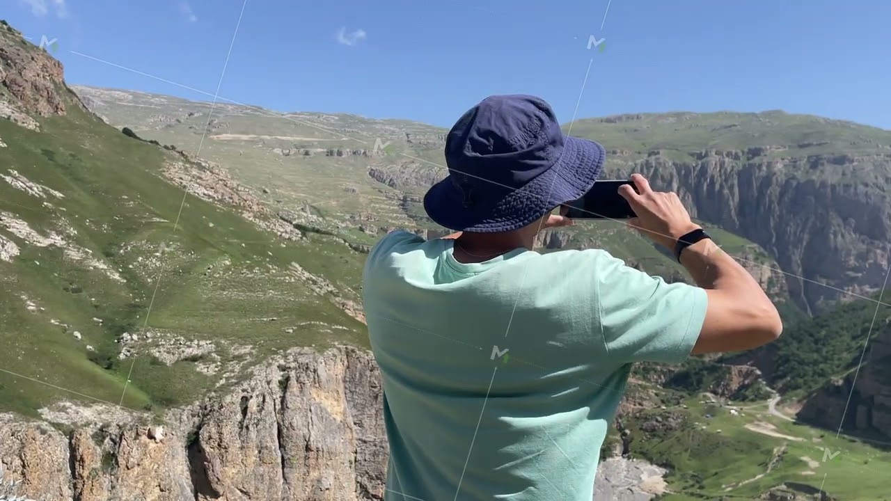 man making picture panorama mountains amateur mobile phone