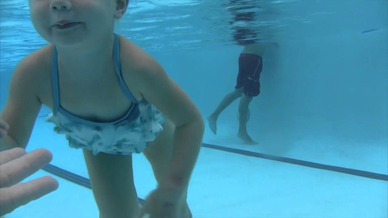 Audrey Davis 3 years old enjoys swimming across and under the water.