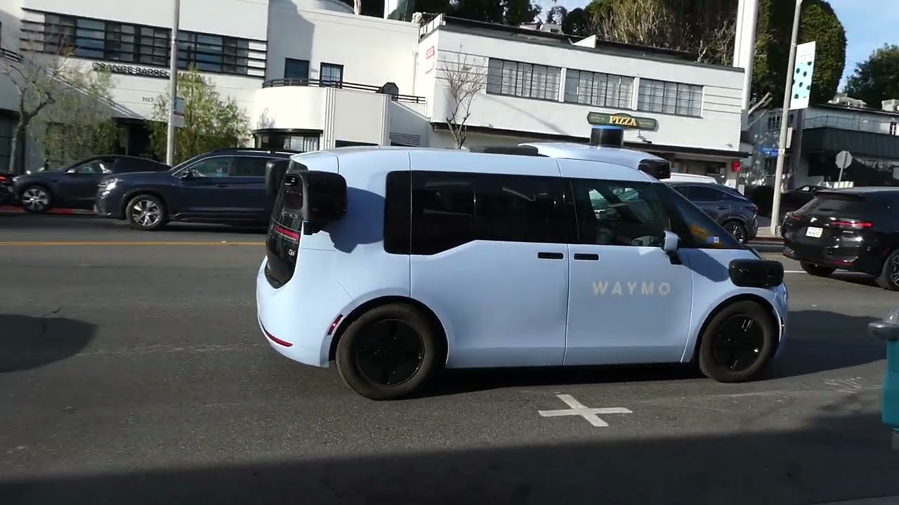 Blue Waymo Van Bus Taxi Driverless Car Billboard Sunset Blvd Los Angeles California March 13, 2026