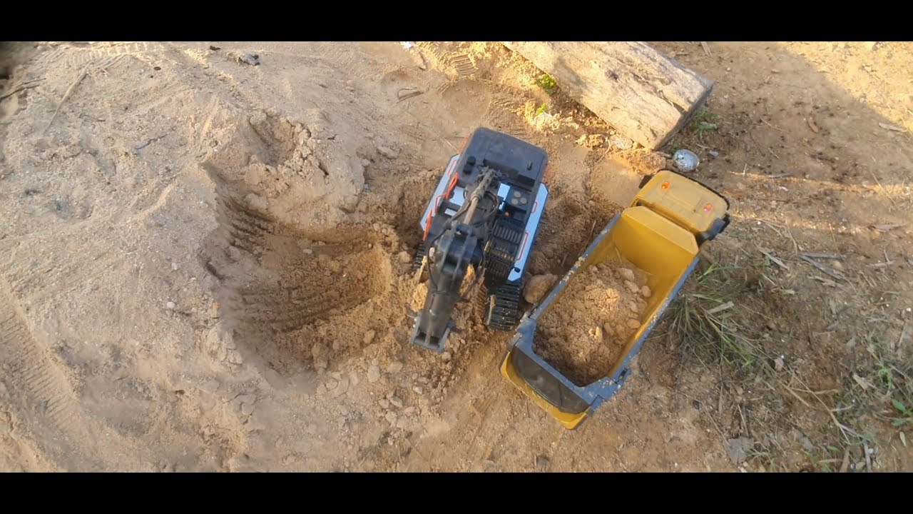 Overhead View of RC Excavator and Dump Truck Digging in Sand