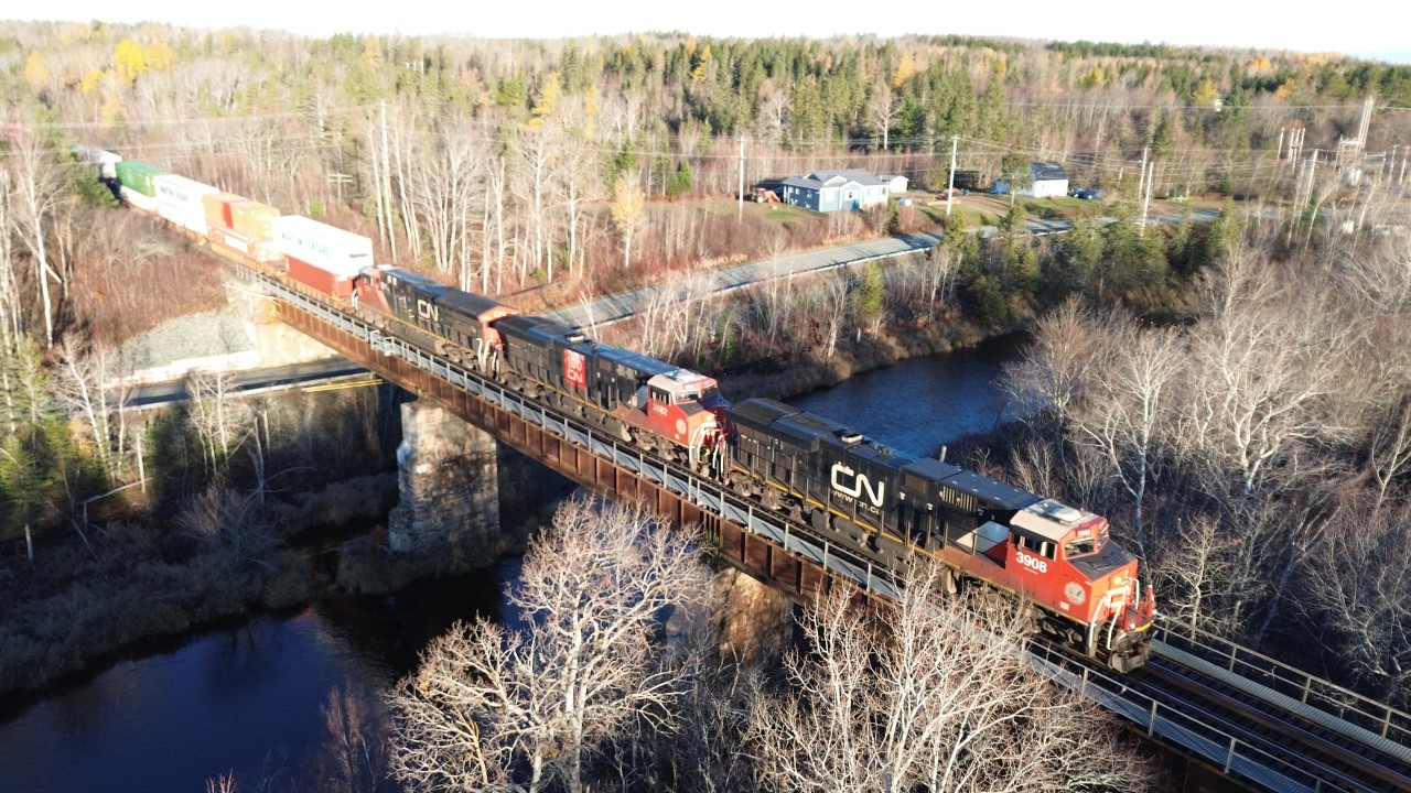 Awesome Aerial 4K View! Big Stack Train CN 120 crossing Bridge in Oxford Junction, NS at Track Speed