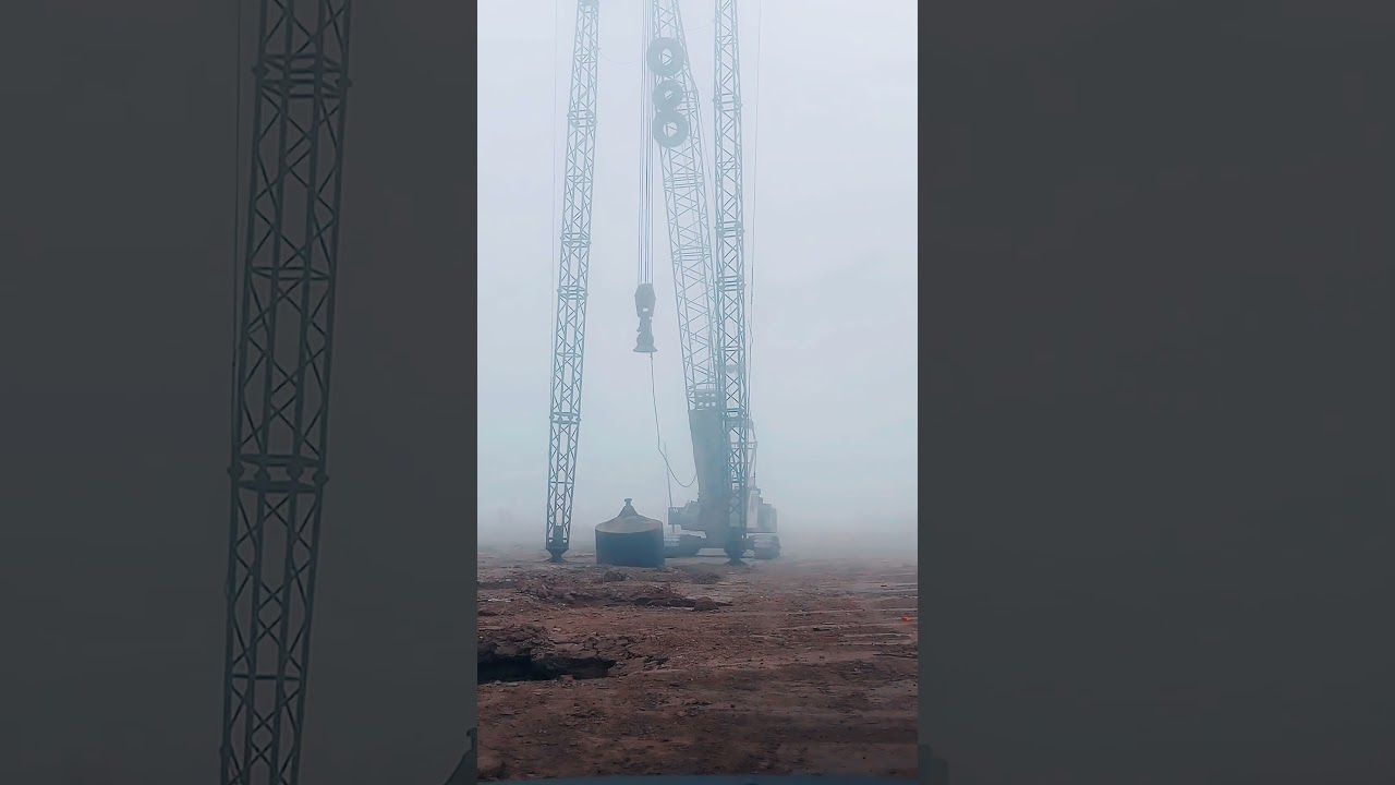 Dynamic compactor surrounded by heavy fog