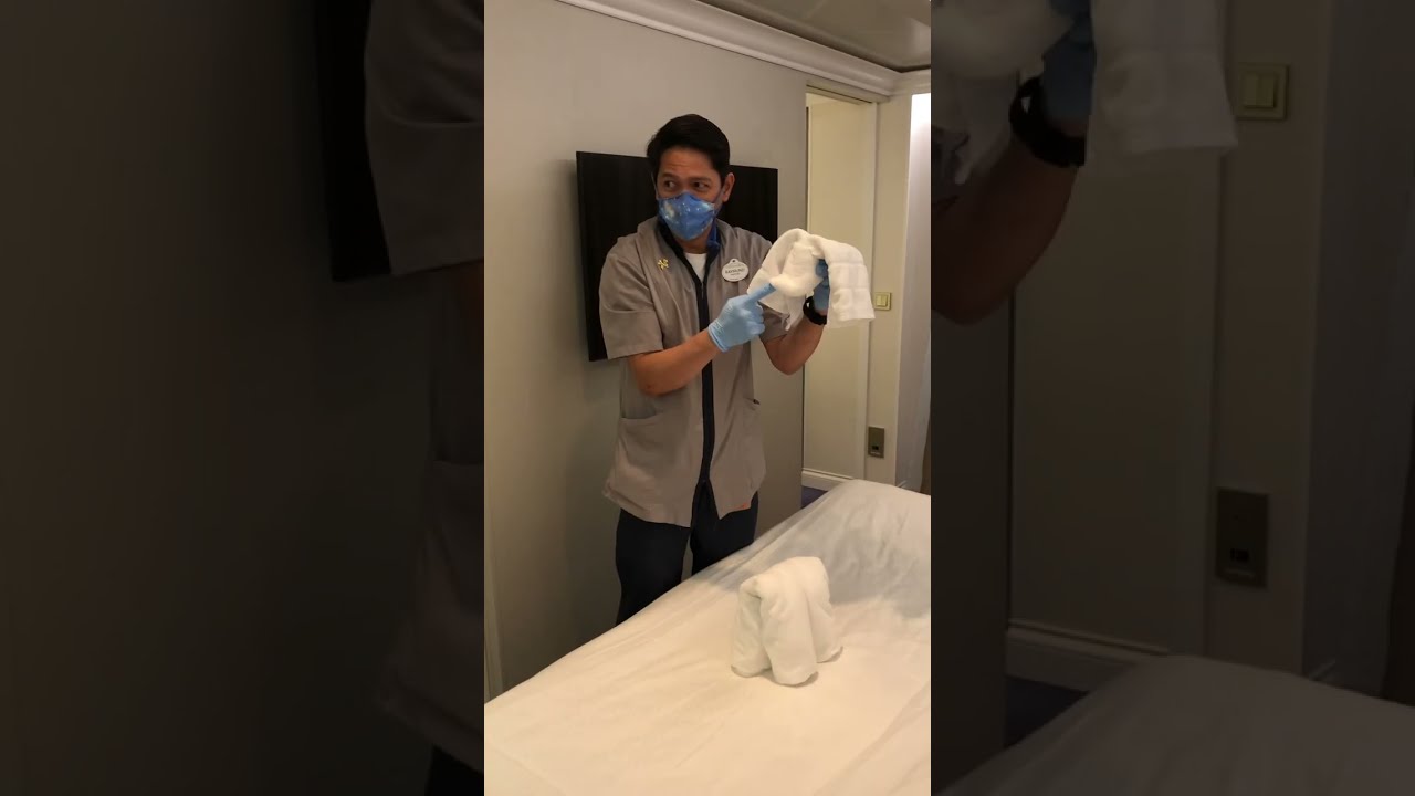 Disney Cruise Line stateroom attendant teaches us how to fold a towel dog