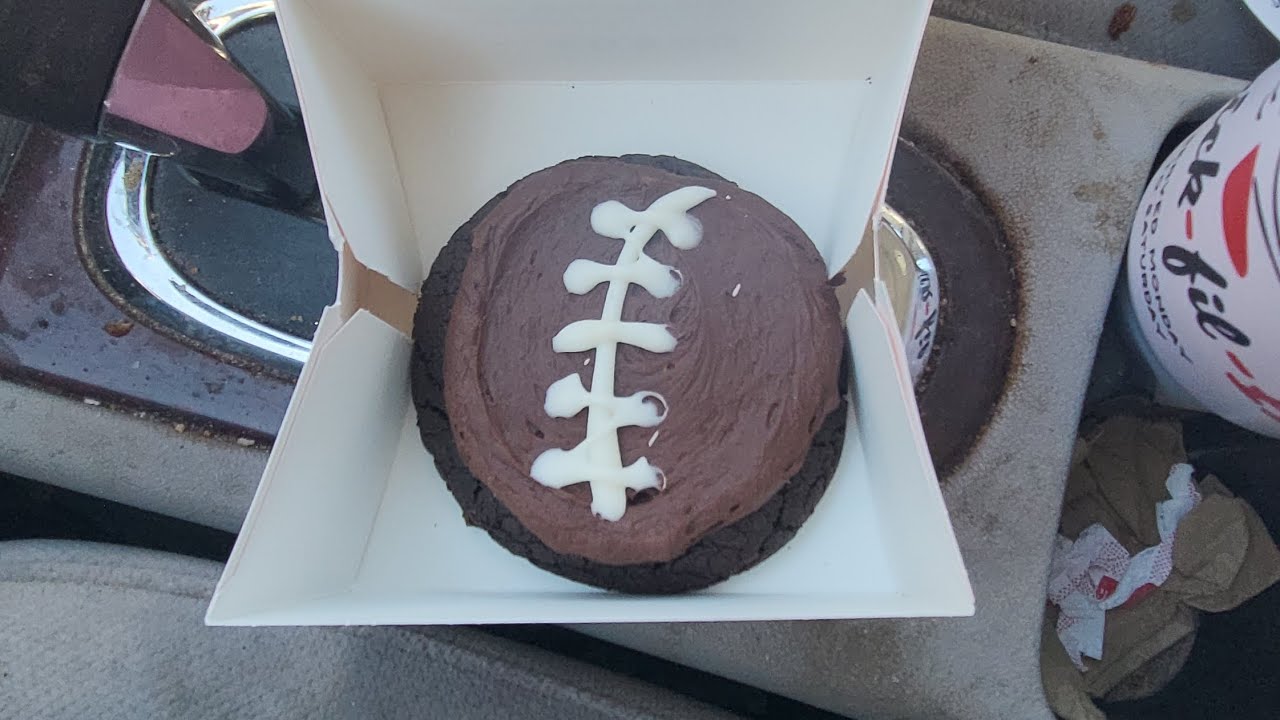 Trying Crumbl new fudge brownie football cookie 