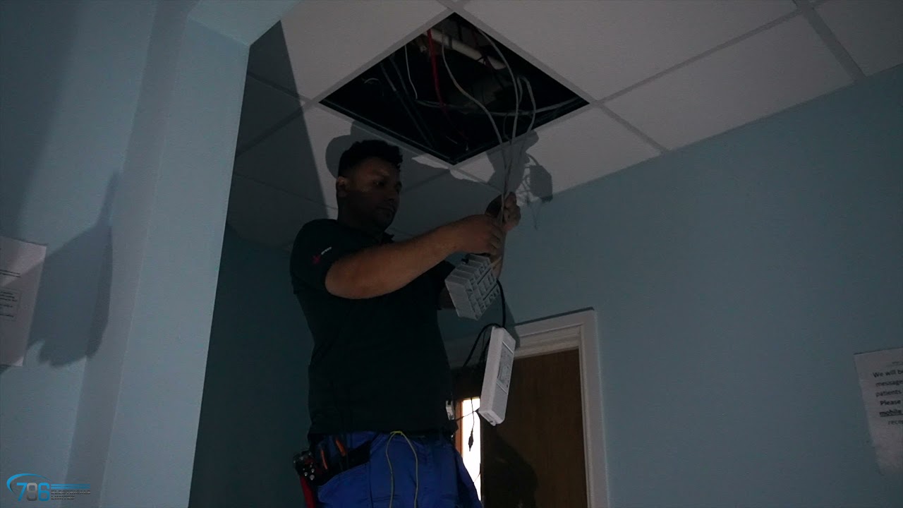 Installation of 600 x 600 LED panel light fitting with emergency capabilities