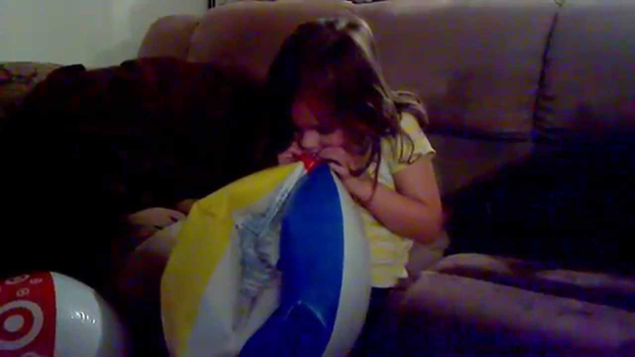 Autumn teaches how to blow up a beach ball