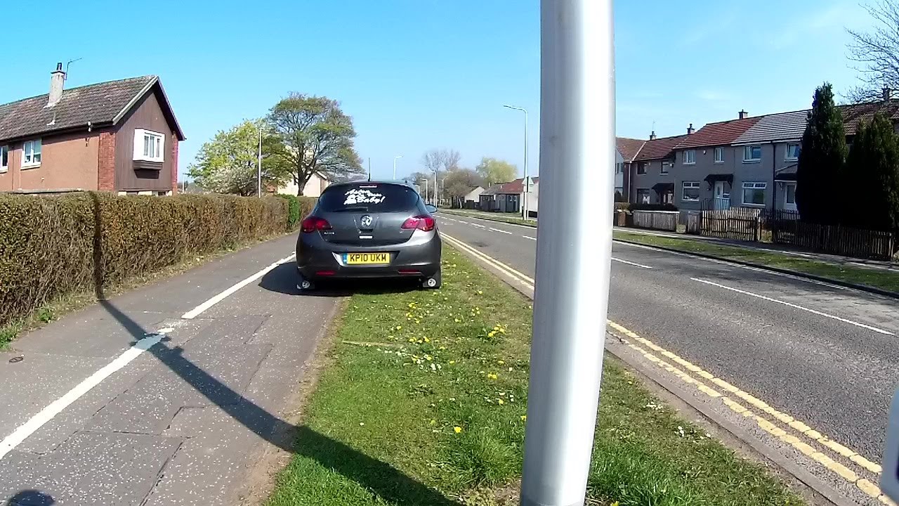 KP10 UKM drives along zebra crossing and footpath