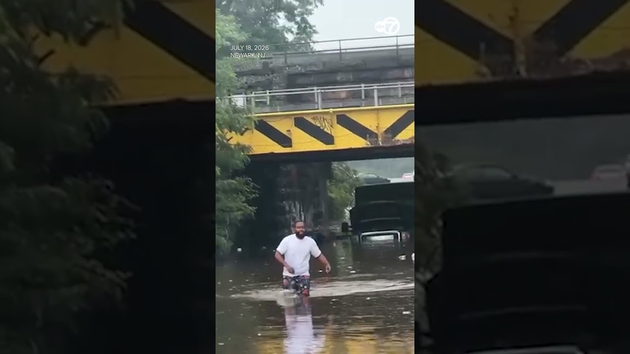 Driver wades through waist high floodwater after vehicle gets stuck