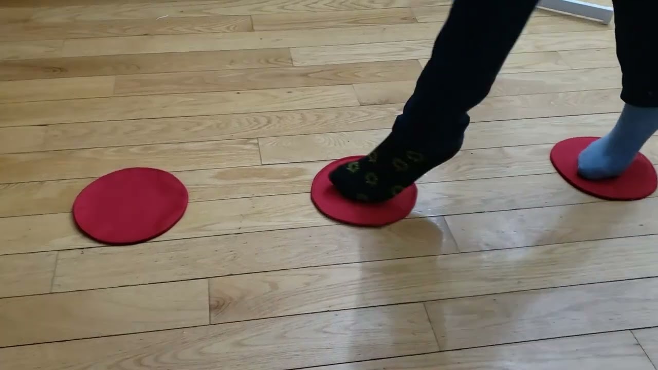 A girl training with ASZORTID Target Shots or Mini Discs in a walking drill motion