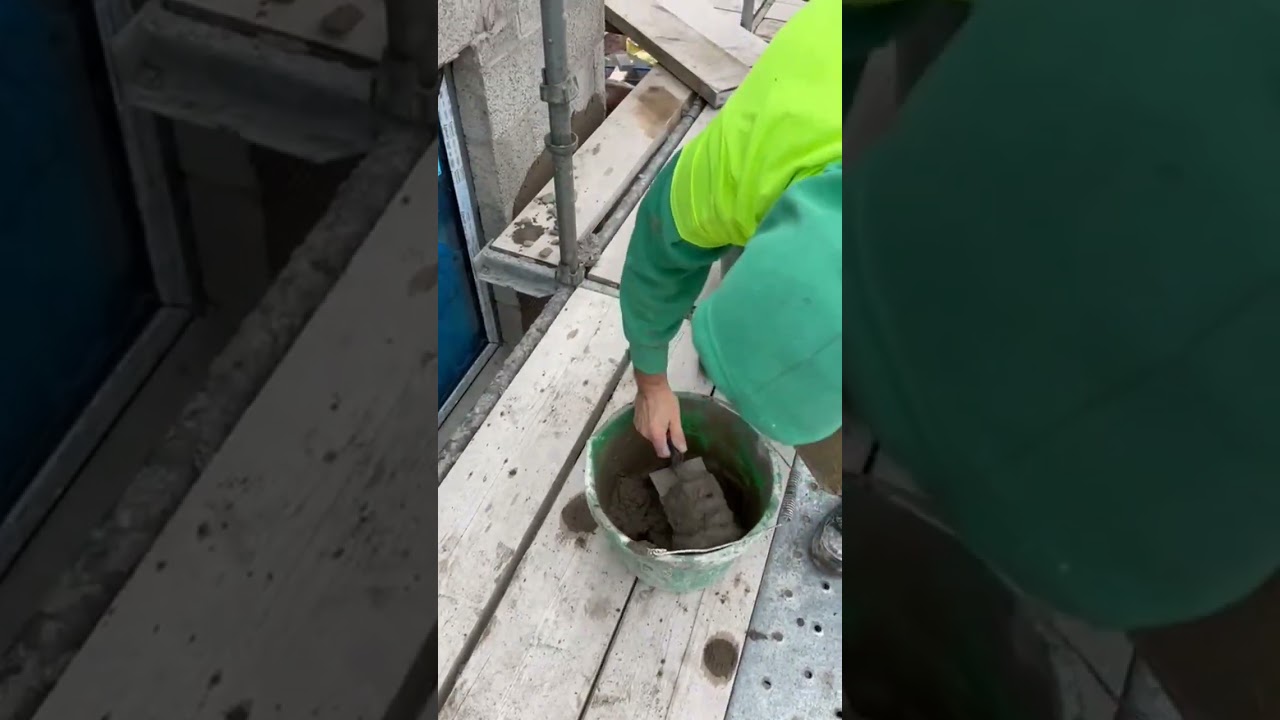 plasterer applying sand cement render concrete block wall using hawk trowel #plastering #satisfying