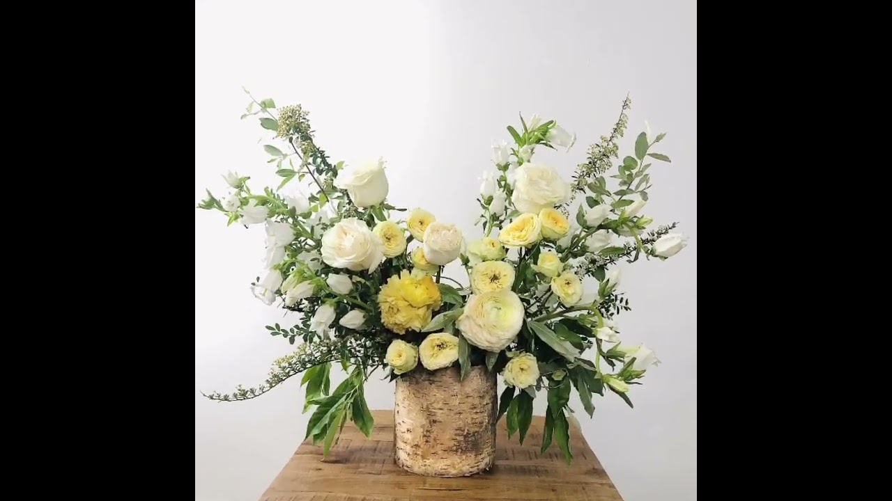 Contemporary white garden rose arrangement in birch container