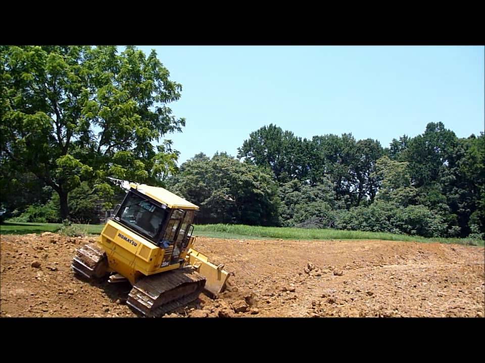 Dozer Cutting Pond Slope