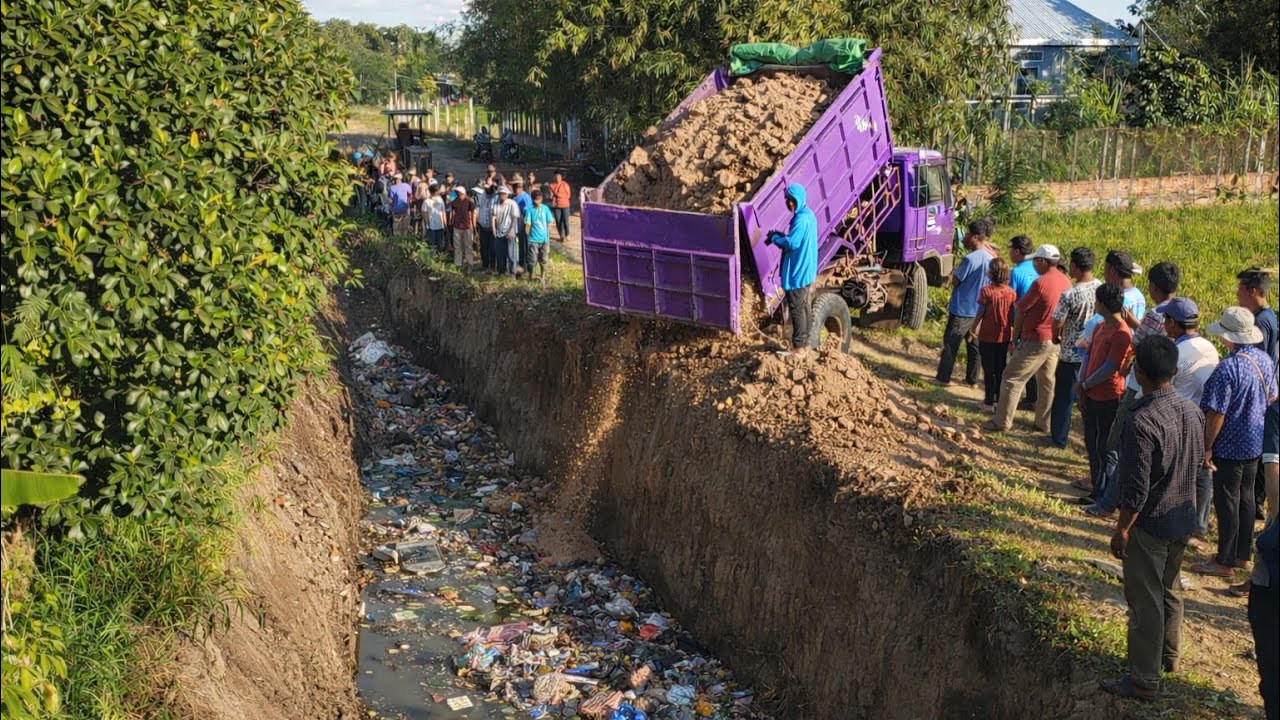 GREAT Job !! Dump truck unloading soil landfilling with Skill operator bulldozer pushing clean up