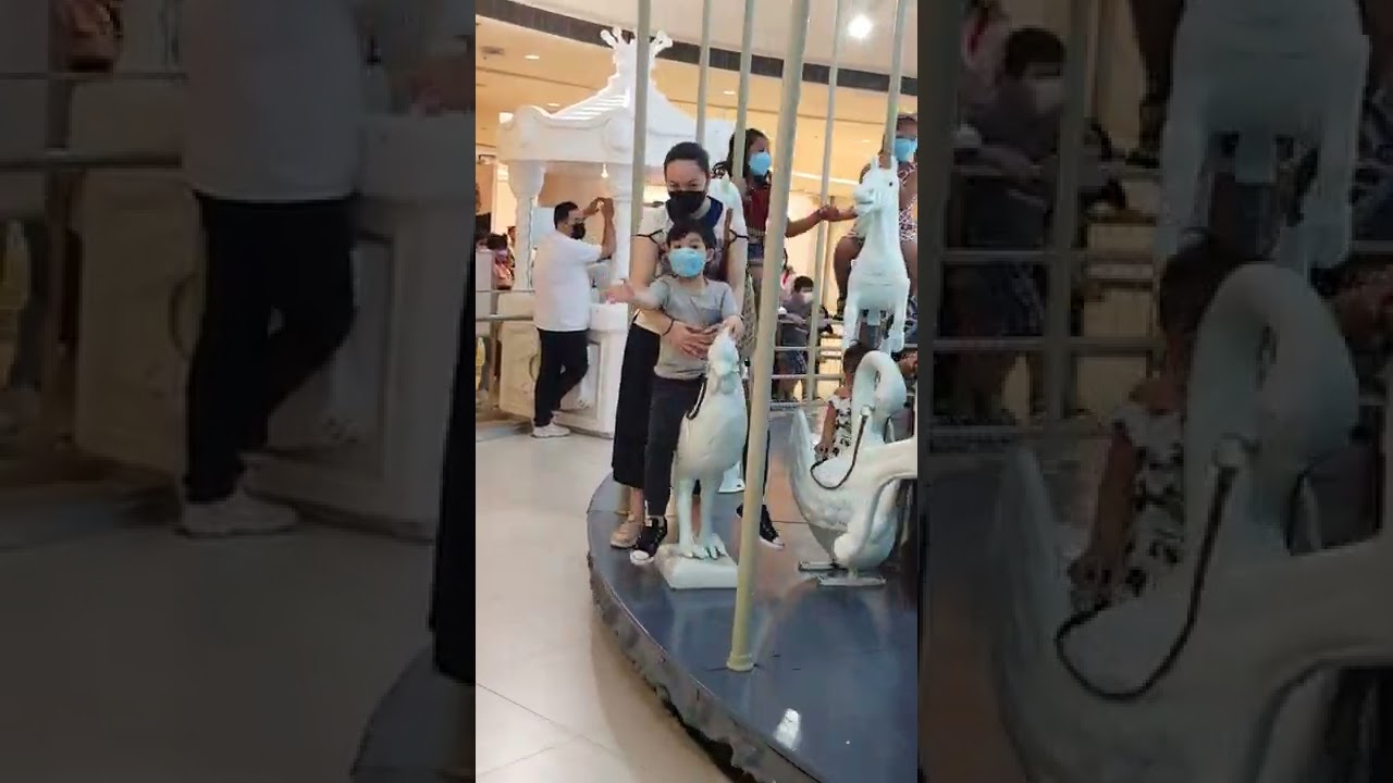 Ryan's riding the chicken in festival mall grand carousel