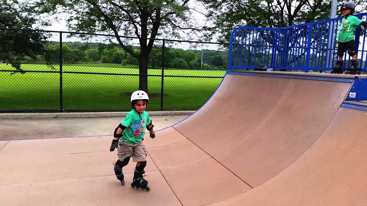 Alex and Dylan rollerblading on the half pipe (7 year olds)