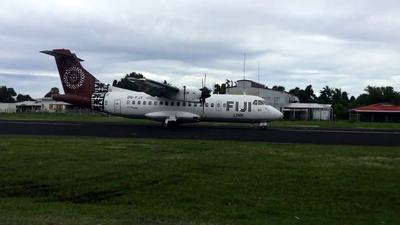 Tuvalu airport. Passengers wait on the runway