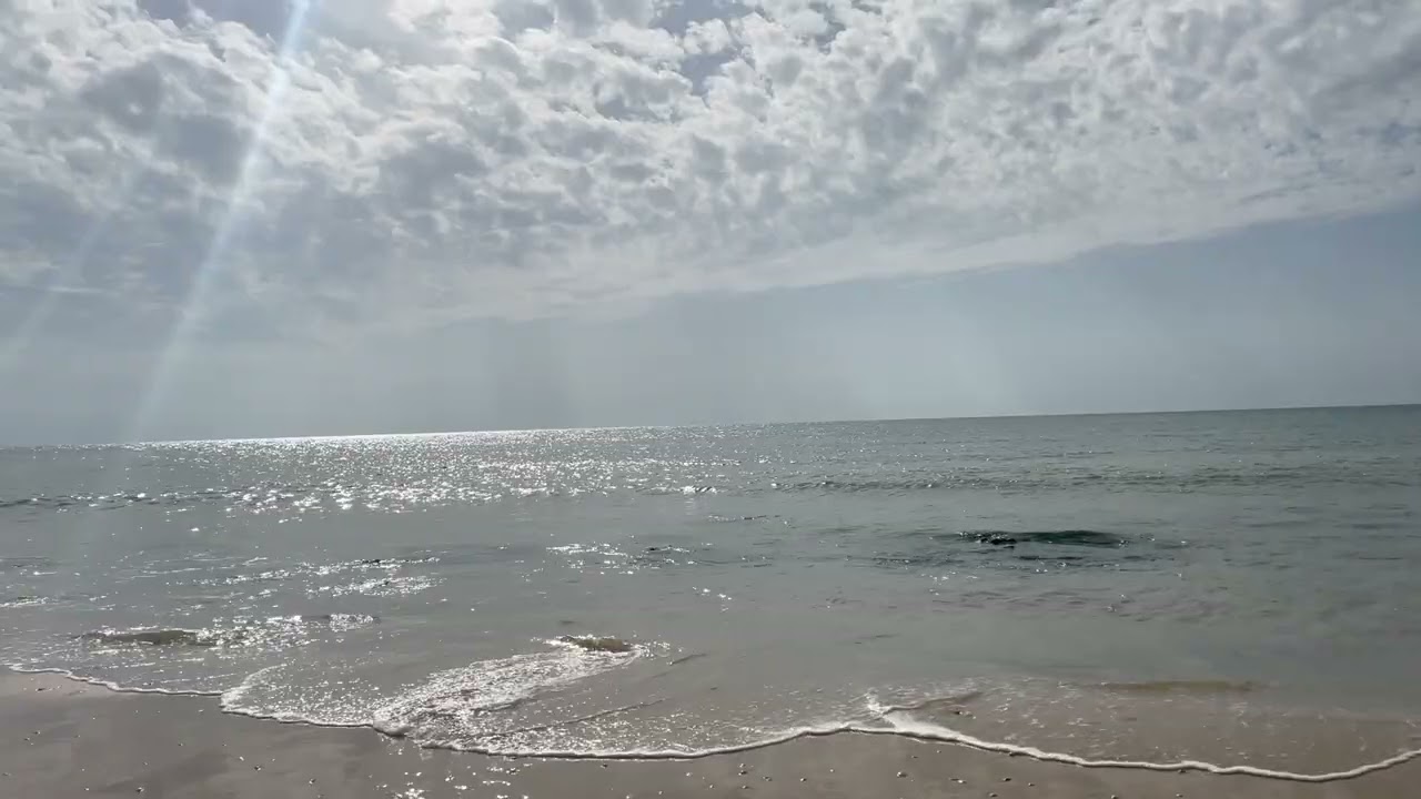 Natural crepuscular rays over the open sea Calm rhythmic ocean textures A super peaceful atmosphere