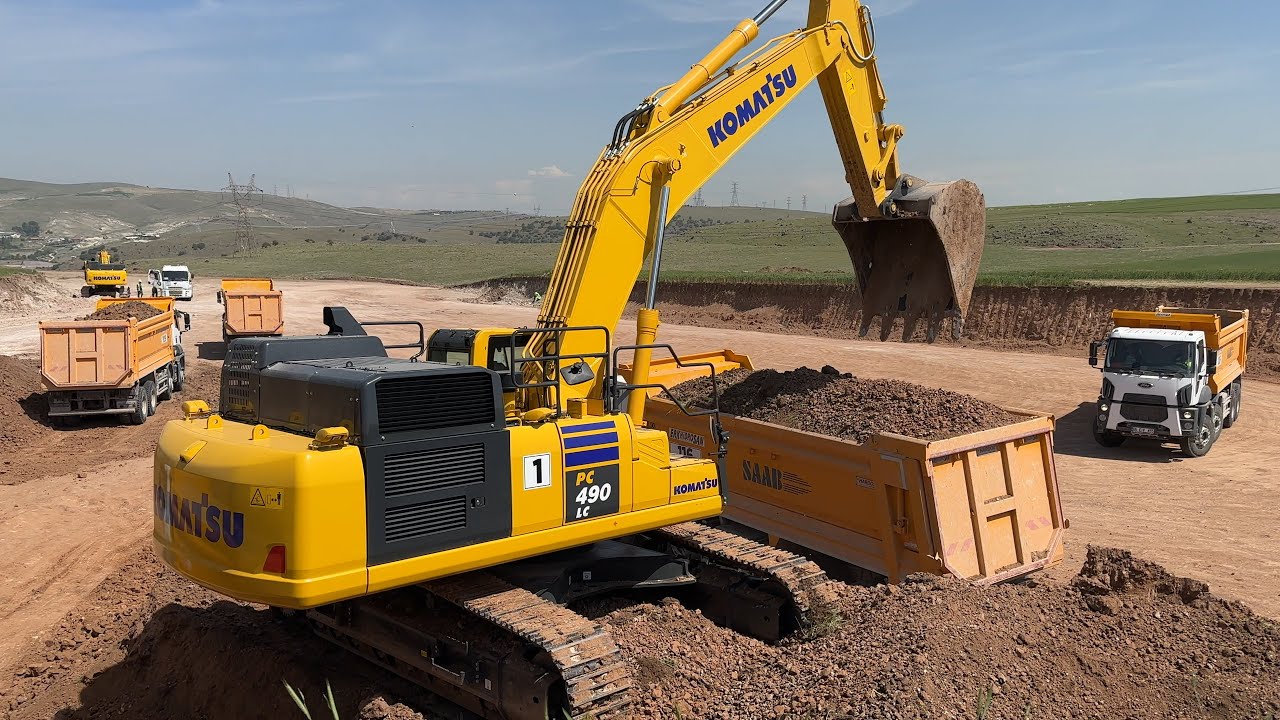 Komatsu Excavator loading double sided truck.