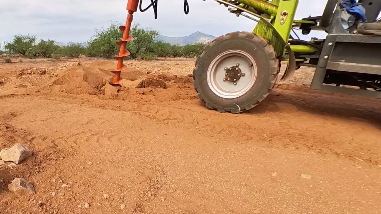 Busting through hard Arizona caliche on NESHER L880 electric loader