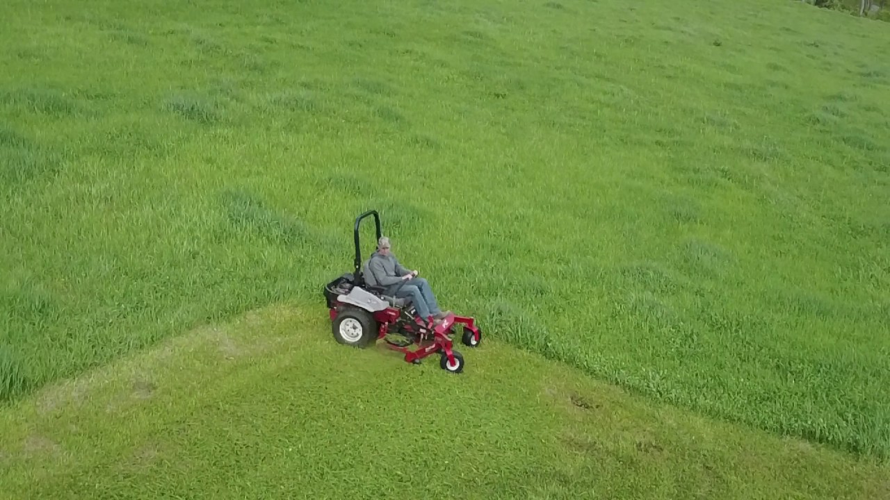 Exmark Lazer Z Mowing Tall Grass Drone Video By QUE Sales Inc