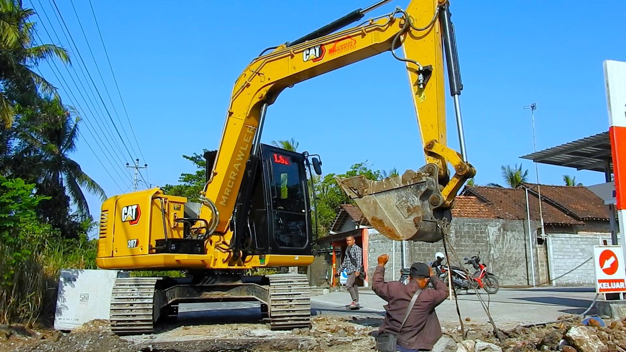 Precision Lifting: CAT 307 Installs Heavy Road Culverts