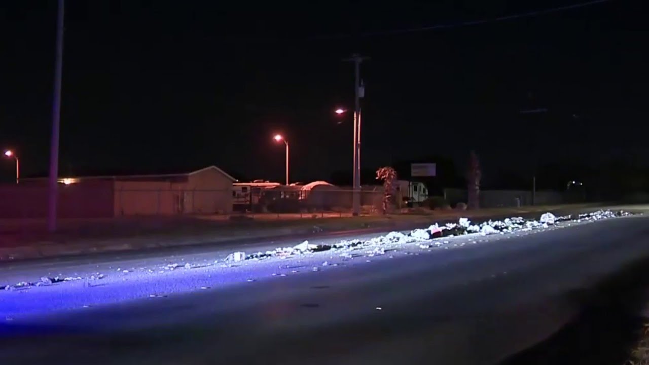 Garbage truck spills trash across road