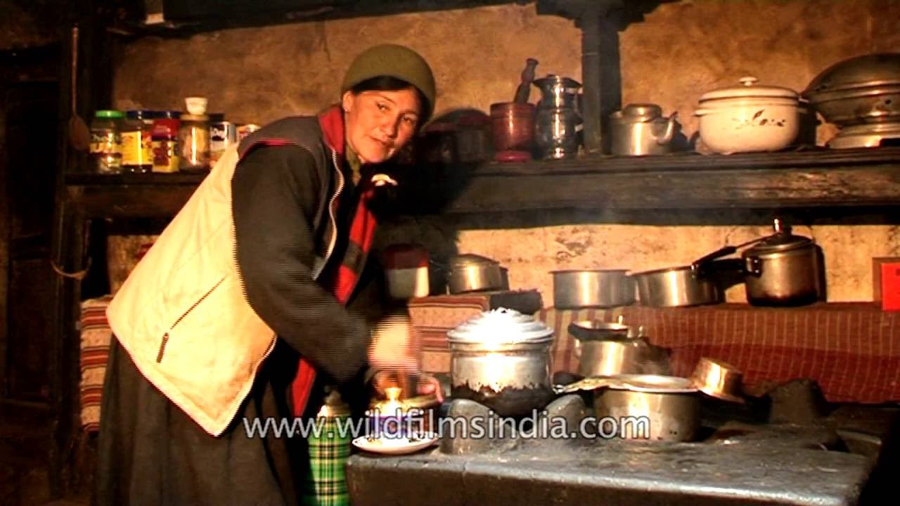 Ladakhi woman makes butter tea in her house