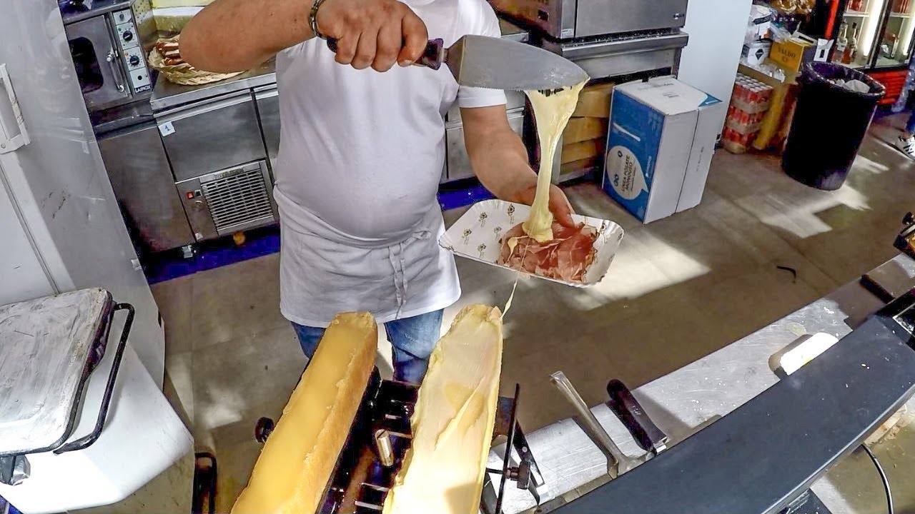 Yummy Raclette. Melted Cheese over Bagel with Ham. Italy Street Food