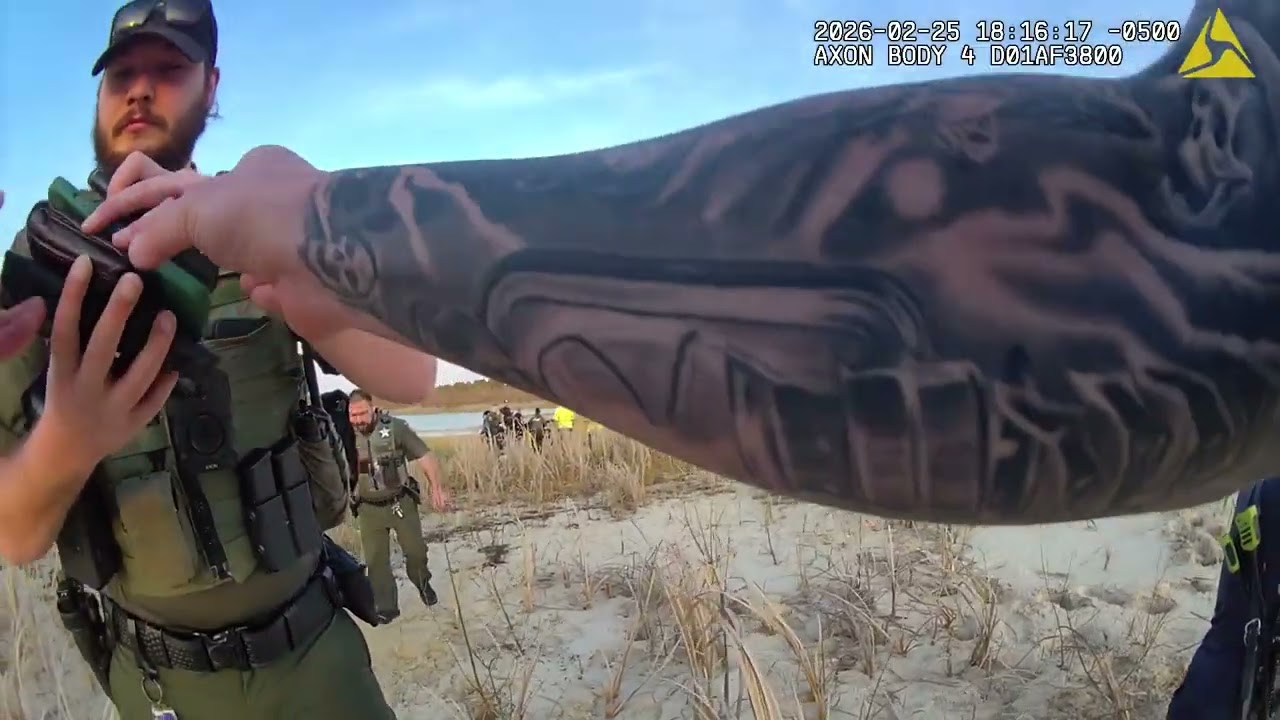 BODYCAM: Deputies, firefighters work to free Florida man stuck in sand pit