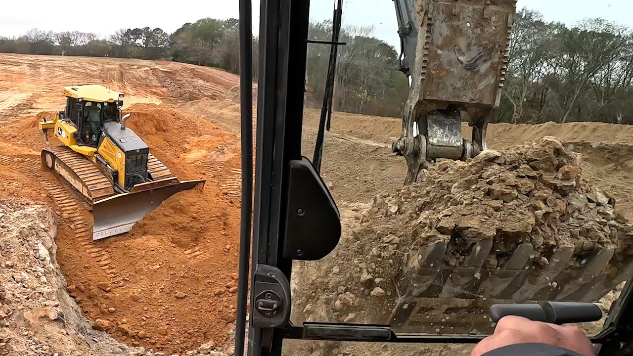 Extending the pond core on the big pond project. Moving dirt with dump trucks and Deere 750L Dozer!