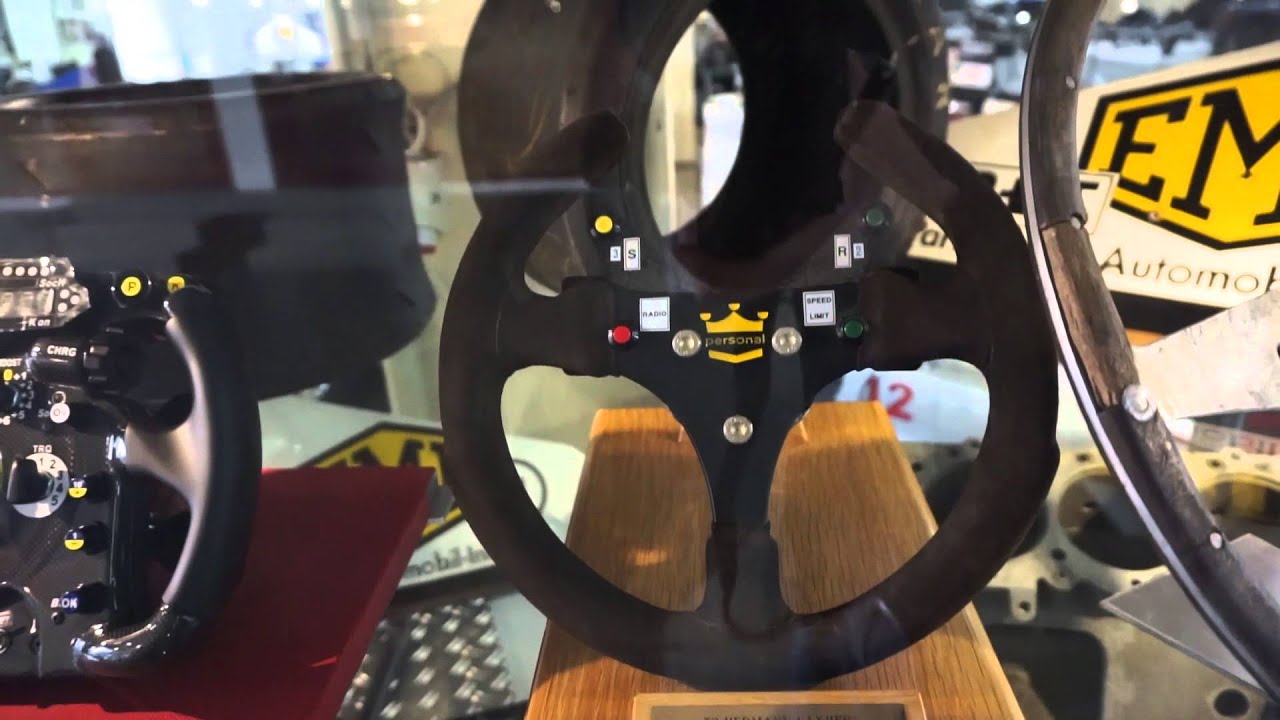 Formula one steering wheels from different decades. + Eddie Irvine Helmet