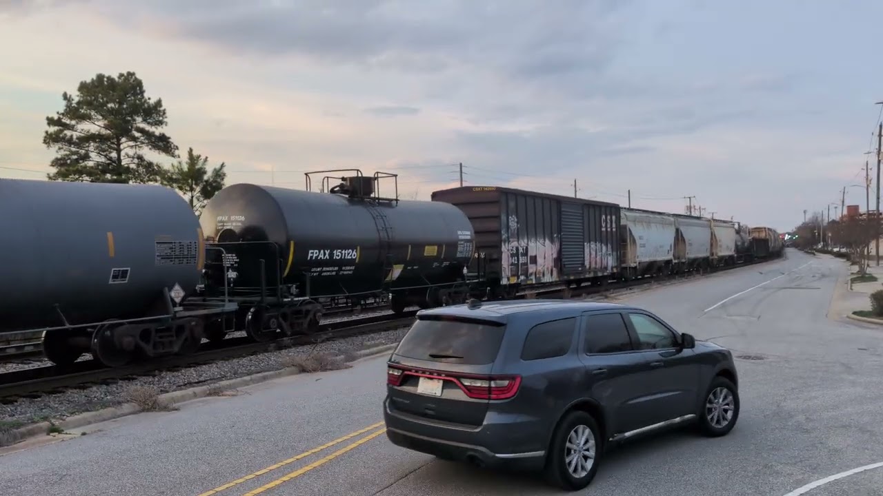 CSX 5484 and CSX 7506 lead a HUGE south bound mixed freight down Winslow Street in Fayetteville 