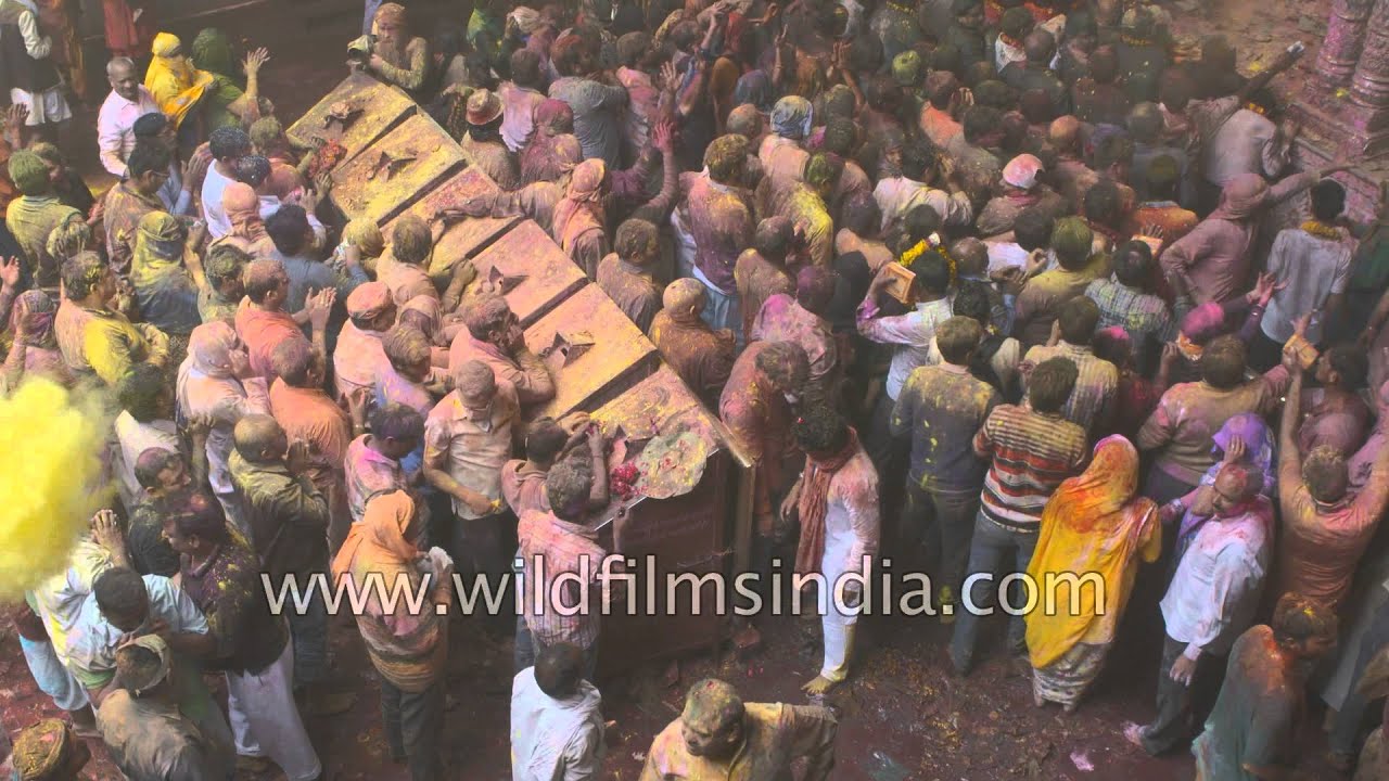 People coated with colours celebrate Holi at Vrindavan, India