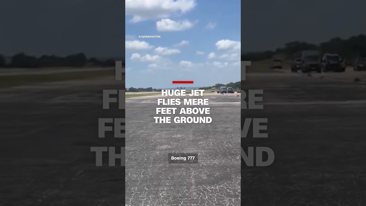 Huge jet flies mere feet above the ground