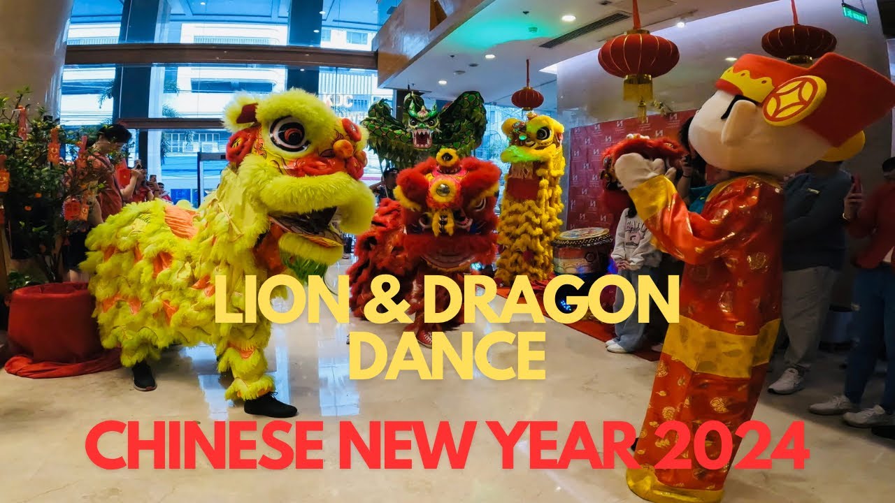 Vibrant traditional dragon and lion dance at a hotel in Manila, Philippines' famous Chinatown..