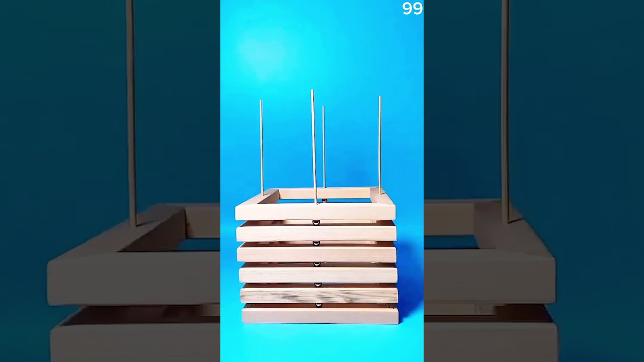 Hot glue secures wooden dowel in base, blue background highlights DIY assembly.