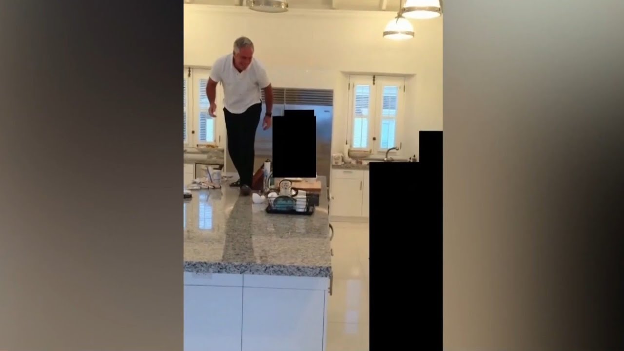Disturbing new video shows Epstein chasing women around the kitchen of his island home