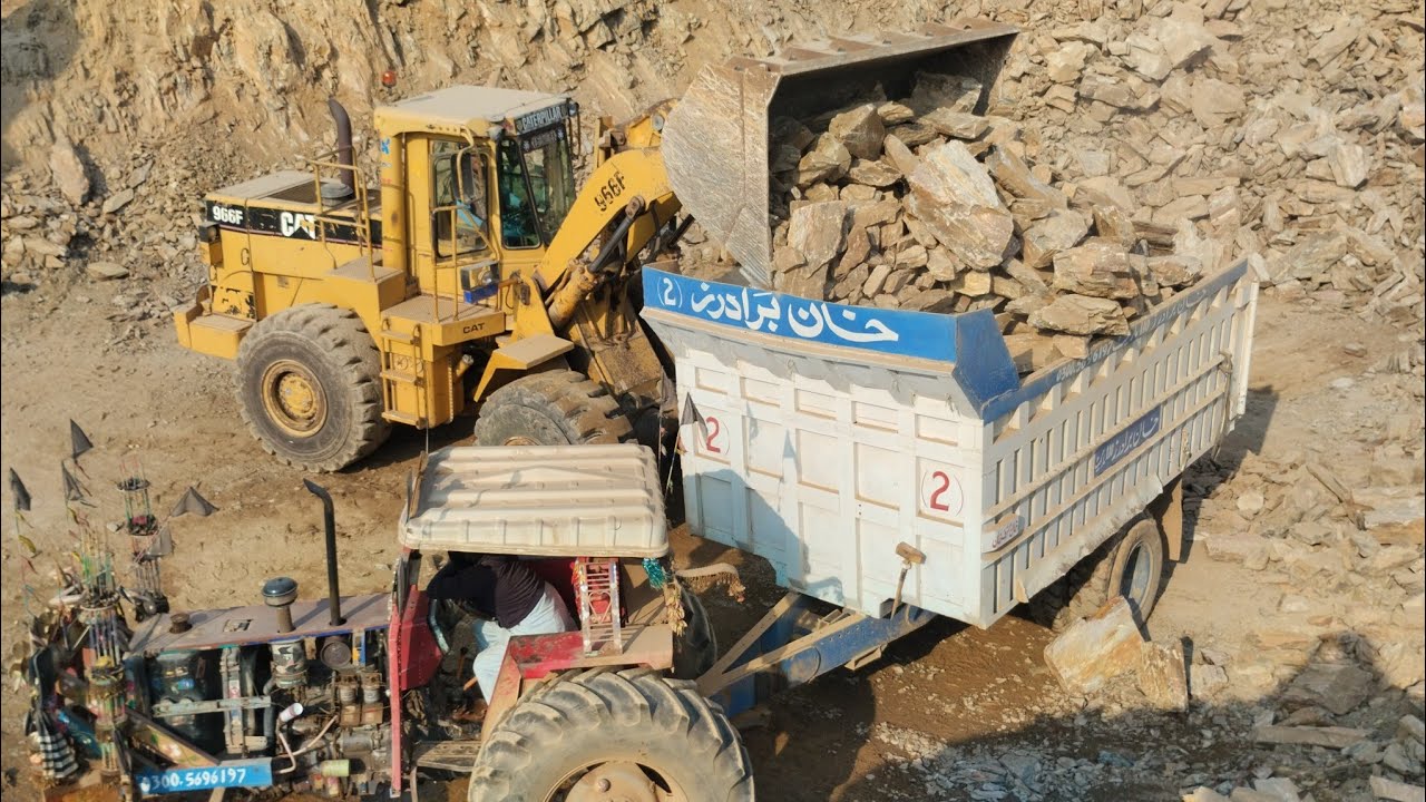 Unleashing Power: Caterpillar 966F Wheel Loader Loading Rocks