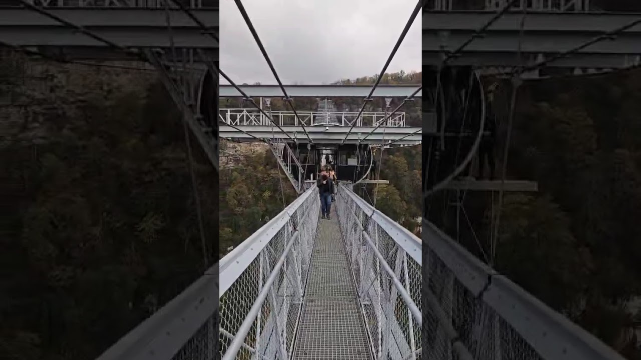 Walk across the bridge over the gorge in the mountains VID 20251110 WA0055