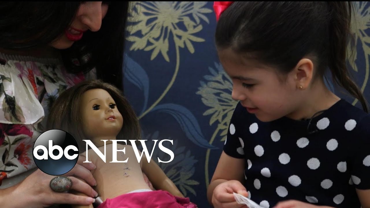 Little girl and her American Girl doll have matching surgery scars