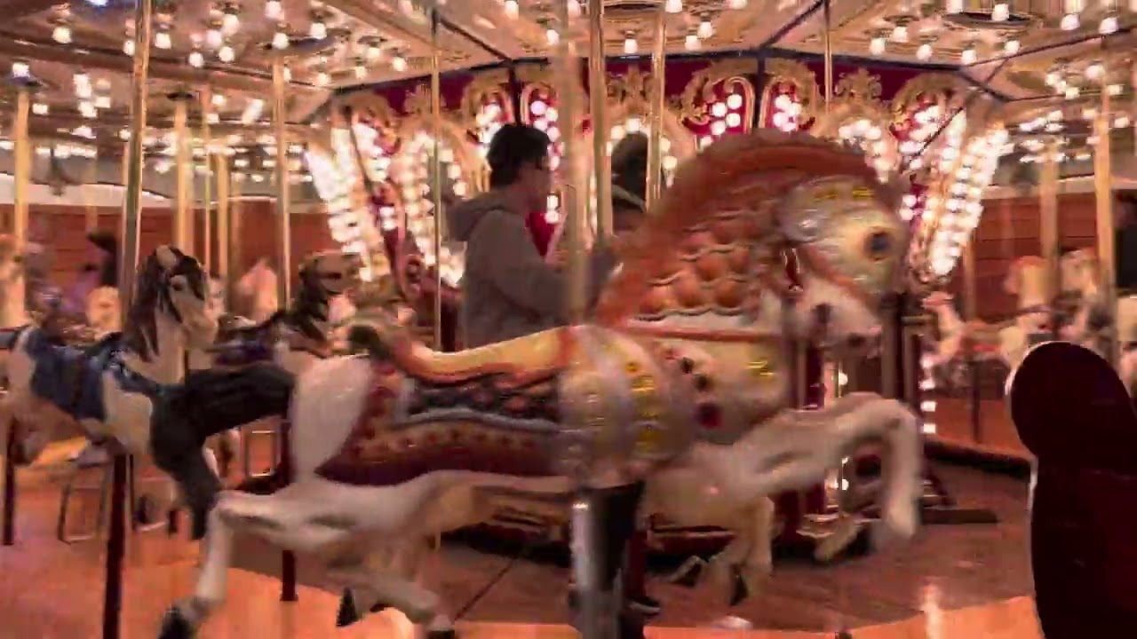 Alexander riding the carousel at Miners Landing at Pier 57 in Seattle
