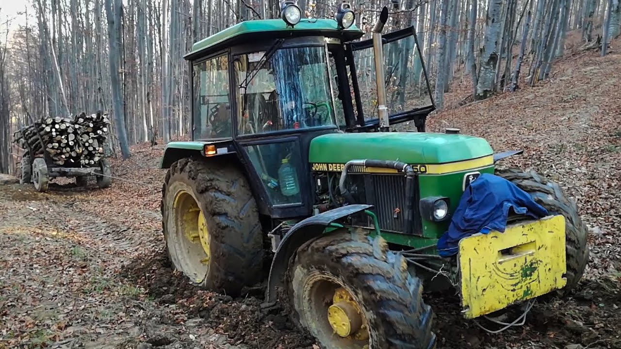 John Deere 2850 Hauling Wood Through Muddy Forest Road.