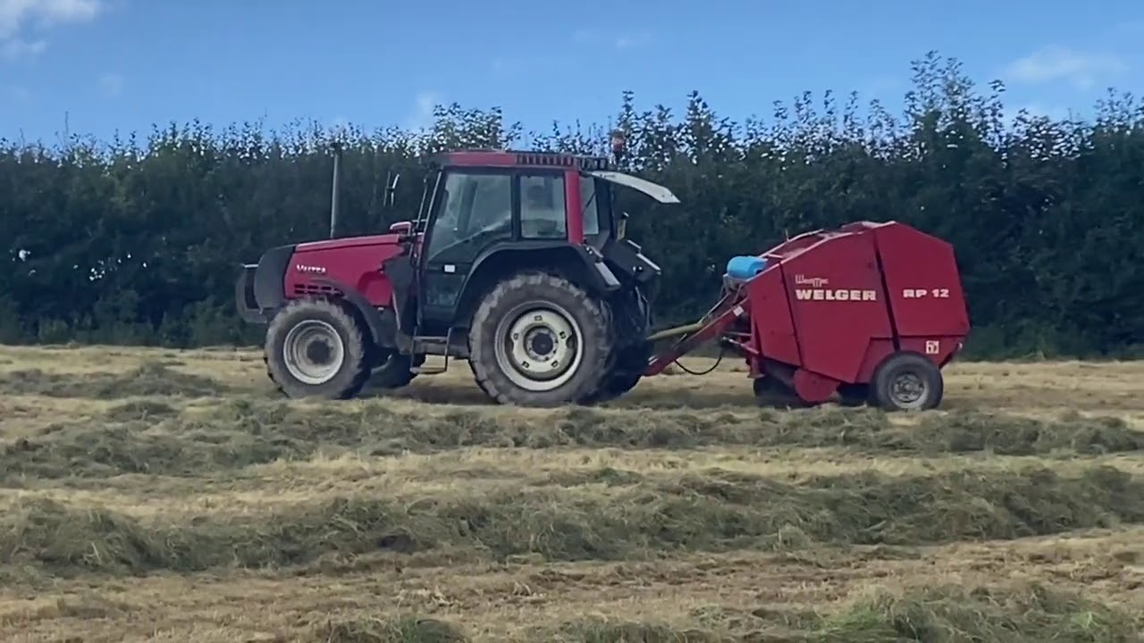 Baling Round Bale Silage With Valtra 6300 and Welger RP12 Baler