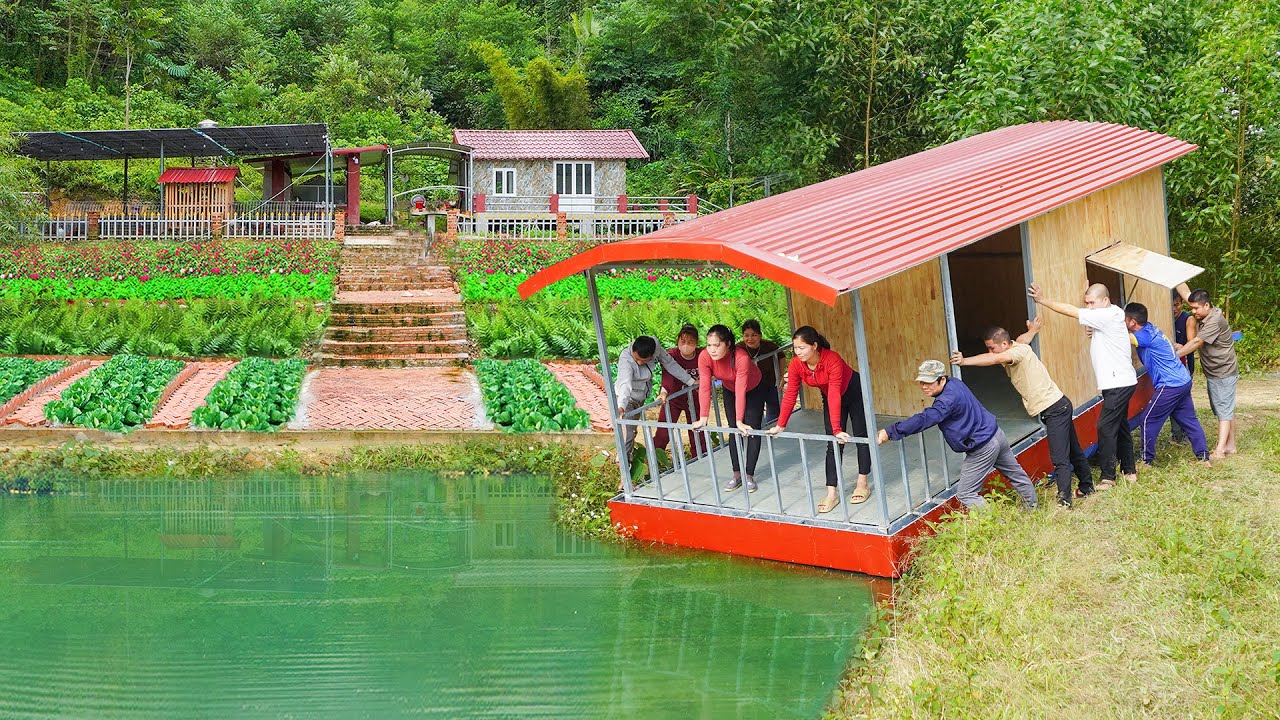 The Floating House Is Complete &ndash; Villagers Help Lower It Into the Large Pond. L&yacute; Ph&uacute;c Vy
