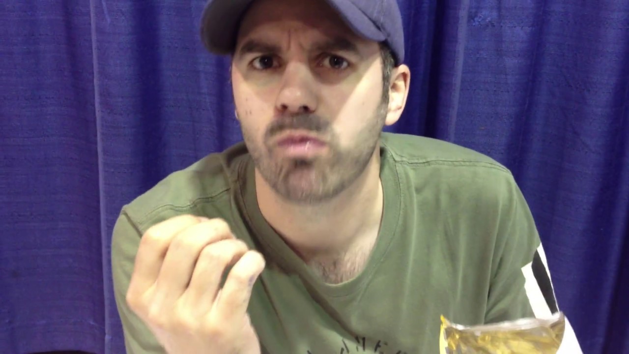 Brad Swaile takes a potato chip and eats it