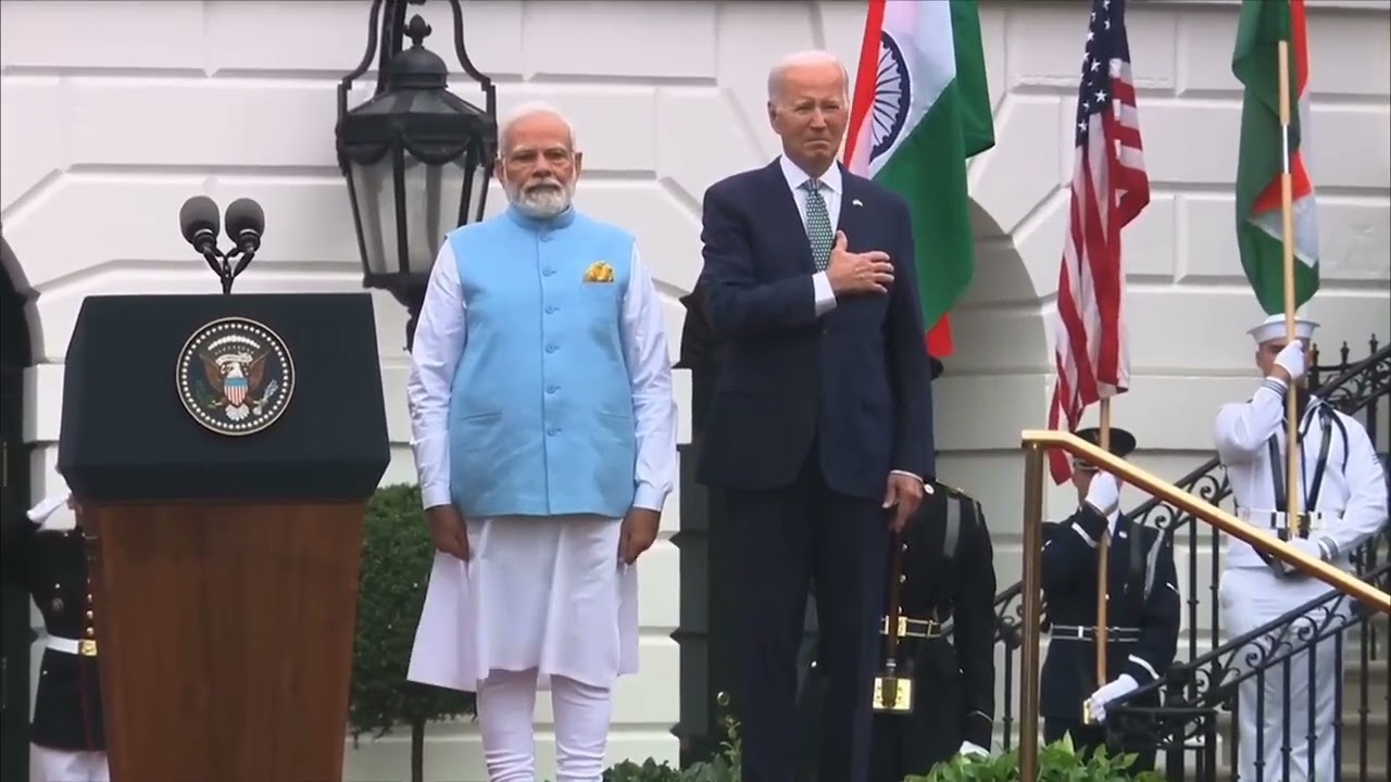 Joe Biden puts his hand on his heart for the India anthem.