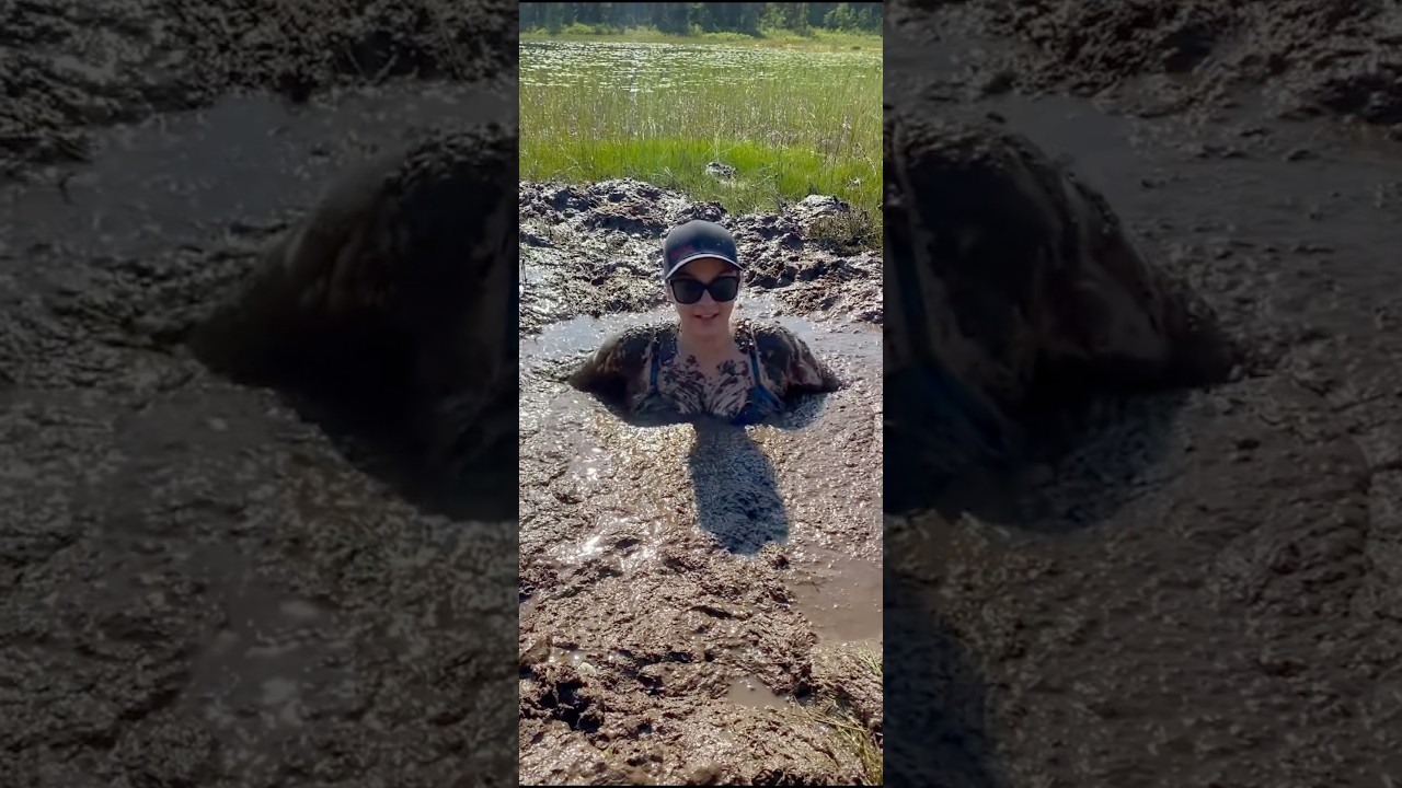 Woman jumps and sinks in the mud but saves herself again.